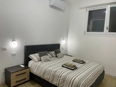 a bedroom with a bed with two phones on it at Condottieri's Hidden Home - Metro C direct to Colosseum in Rome