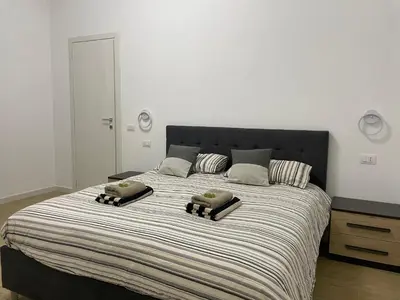 a bedroom with a large bed with two pillows on it at Condottieri's Hidden Home - Metro C direct to Colosseum in Rome