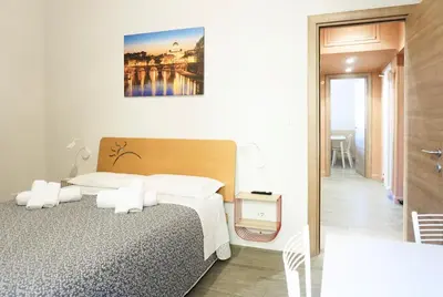 a hotel room with a bed and a bathroom at Cozy Apartment in the heart of Garbatella in Rome