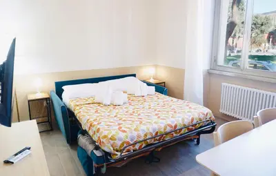 a bedroom with a bed with two pillows on it at Cozy Apartment in the heart of Garbatella in Rome