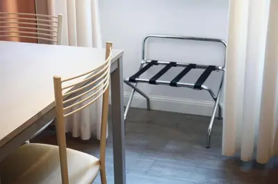 a chair sitting next to a table in a room at Cozy Apartment in the heart of Garbatella in Rome
