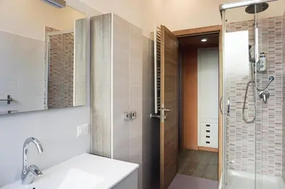 a bathroom with a shower and a sink and a glass door at Cozy Apartment in the heart of Garbatella in Rome