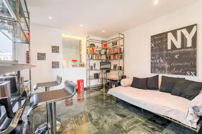 a living room with a couch and a chalkboard on the wall at Comics Roma Penthouse, Funny Flat Nearby Colosseum in Rome