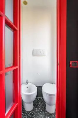 a bathroom with a white toilet and a sink at Comics Roma Penthouse, Funny Flat Nearby Colosseum in Rome