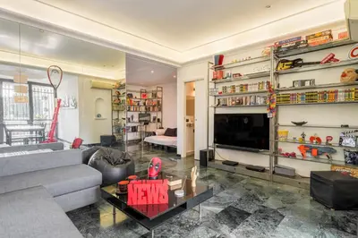 a living room with a couch and a table with a spider man on it at Comics Roma Penthouse, Funny Flat Nearby Colosseum in Rome