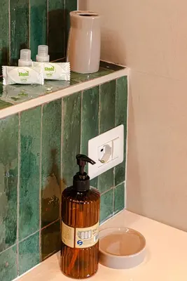 a soap dispenser sitting on top of a bathroom counter at Sangió - Lovely Home in Rome in Rome