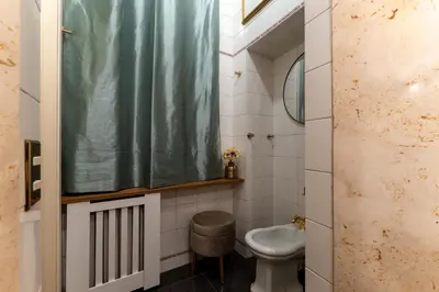 a bathroom with a shower curtain and a toilet at Navona Sweet Loft in Rome