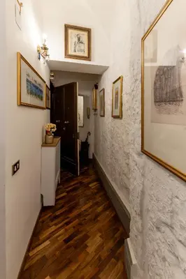 a hallway with wood floors and paintings on the walls at Navona Sweet Loft in Rome