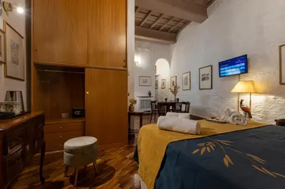 a bedroom with a bed and a table and chairs at Navona Sweet Loft in Rome