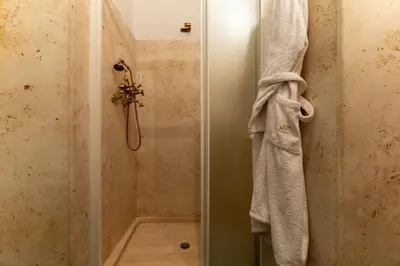 a shower with a white towel hanging on a wall at Navona Sweet Loft in Rome