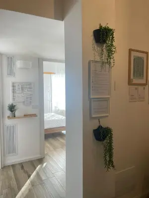 a hallway with plants on the wall and a bedroom at Appartamento 2 bagni, 2 camere a Piramide ostiense in Rome