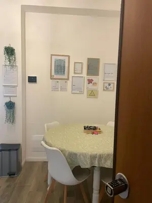 a table in a room with a table and a chair at Appartamento 2 bagni, 2 camere a Piramide ostiense in Rome