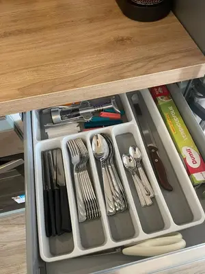 a drawer filled with silver utensils on a table at Appartamento 2 bagni, 2 camere a Piramide ostiense in Rome