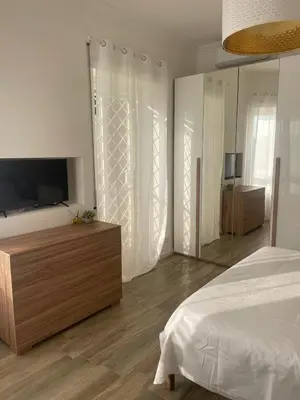 a bedroom with a bed and a flat screen tv at Appartamento 2 bagni, 2 camere a Piramide ostiense in Rome