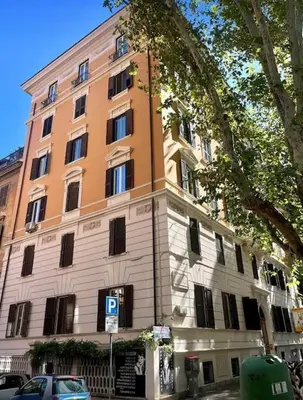a large building with a parking meter in front of it at Camelia's Garden in Rome