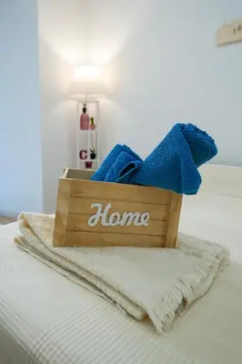 a box of towels sitting on top of a bed at Camelia's Garden in Rome