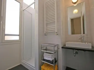 a white bathroom with a sink and a mirror at Suite Cernaia Holidays in Rome