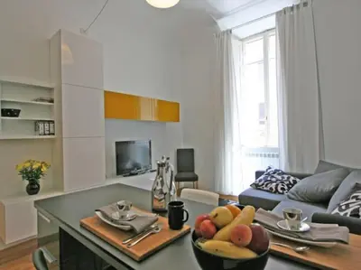 a living room with a table with a bowl of fruit at Suite Cernaia Holidays in Rome