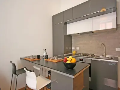 a kitchen with a bowl of fruit on a counter at Suite Cernaia Holidays in Rome