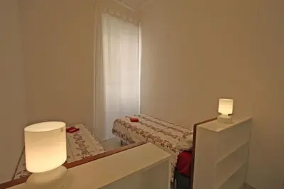 a small room with a bed and a mirror at Suite Boschetto Holidays in Rome