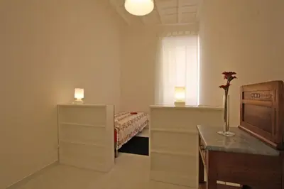 a bedroom with a bed and a desk and a window at Suite Boschetto Holidays in Rome