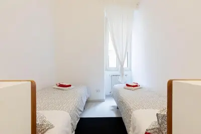 two beds in a room with a window at Suite Boschetto Holidays in Rome