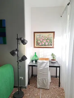 a room with a desk with a chair and a painting at Appartamento Prenestina 74 in Rome