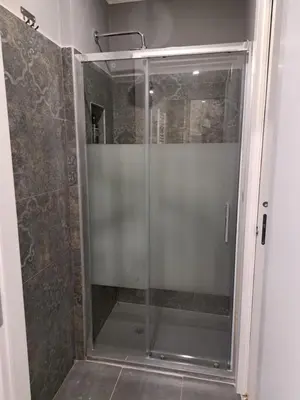 a shower with a glass door in a bathroom at Appartamento Prenestina 74 in Rome