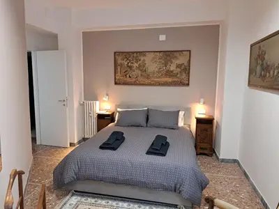 a bedroom with a bed with two black towels on it at Appartamento Prenestina 74 in Rome