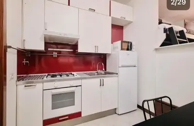 a small patio with a white chair and a table at Trastevere luxury apartment in Rome