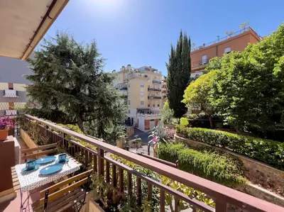 a balcony with a table and a view of a city at Gozzadini Apartment in Rome