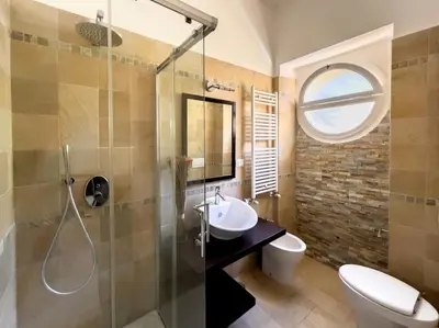 a bathroom with a sink and a shower and a toilet at Gozzadini Apartment in Rome