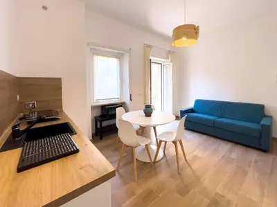 a living room with a blue couch and a table at Gozzadini Apartment in Rome