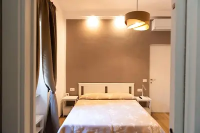 a bedroom with a large bed in a room at Gozzadini Apartment in Rome