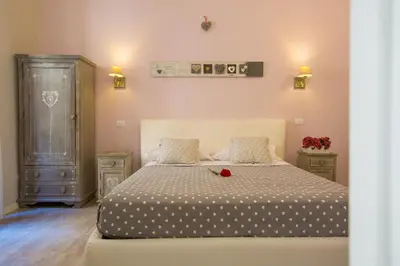 a bedroom with a bed with a flower on it at B&B Vatican's Keys in Rome