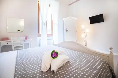 a bedroom with a bed with a rose on it at B&B Vatican's Keys in Rome