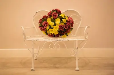 a white chair with a bouquet of flowers on it at B&B Vatican's Keys in Rome