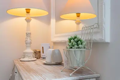 a table with two lamps and a potted plant on it at B&B Vatican's Keys in Rome