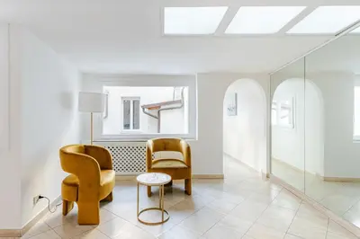 a living room with two chairs and a table at Campo de Fiori - Casa Storica 4bdr con Terrazza in Rome