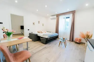 a living room with a bed and a table at Maison Pesca in Rome