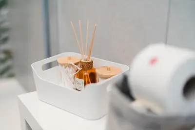 a white container with a bottle of honey and sticks at Maison Pesca in Rome