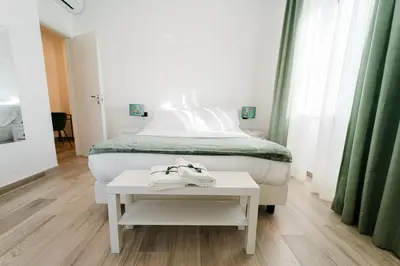 a bedroom with a bed and a table with towels on it at Maison Salvia in Rome