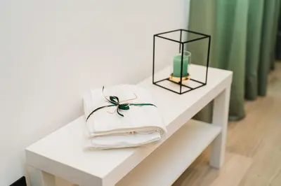 a white table with towels and a candle on it at Maison Salvia in Rome
