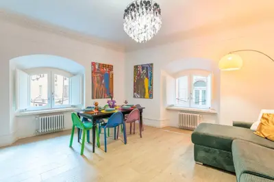 a living room with a table and chairs and a couch at Casa degli Dei in Rome