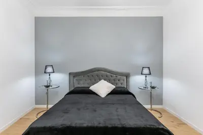 a bedroom with a large bed with two lamps at Casa degli Dei in Rome