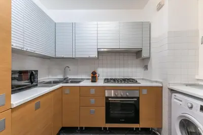 a kitchen with a sink and a stove top oven at Casa degli Dei in Rome