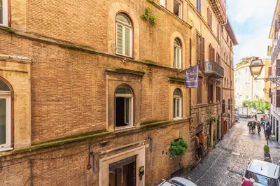 an old brick building on a city street at Casa degli Dei in Rome
