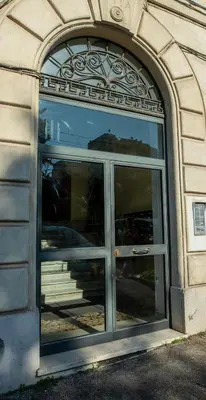 an entrance to a building with a large glass door at UrbanPiramide - Roma in Rome