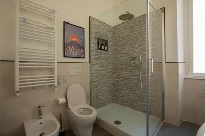 a bathroom with a shower and a toilet and a sink at UrbanPiramide - Roma in Rome