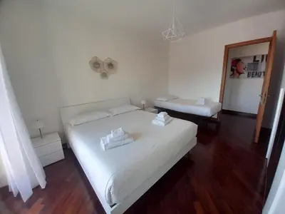a bedroom with a large white bed and a mirror at St Peter's view penthouse 300 mt metro A stop in Rome